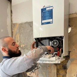 Skilled home plumber at work in North London